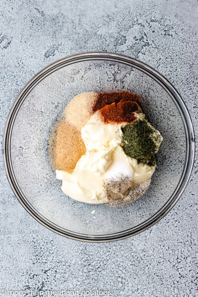 Top down view of mayonnaise and spices in a bowl.