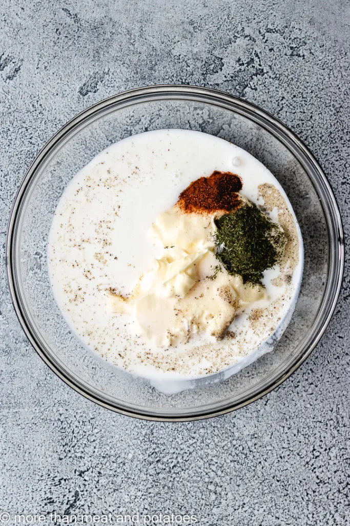 Ingredients for chipotle ranch dressing in a glass bowl.