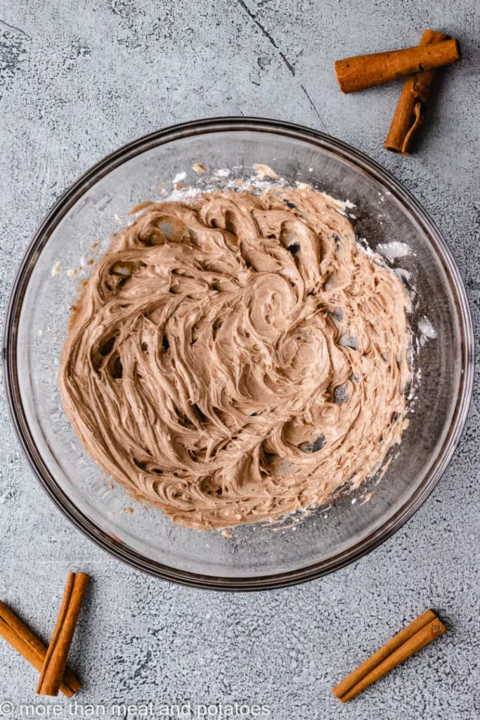 Top down view of mixed cinnamon butter in a glass bowl.