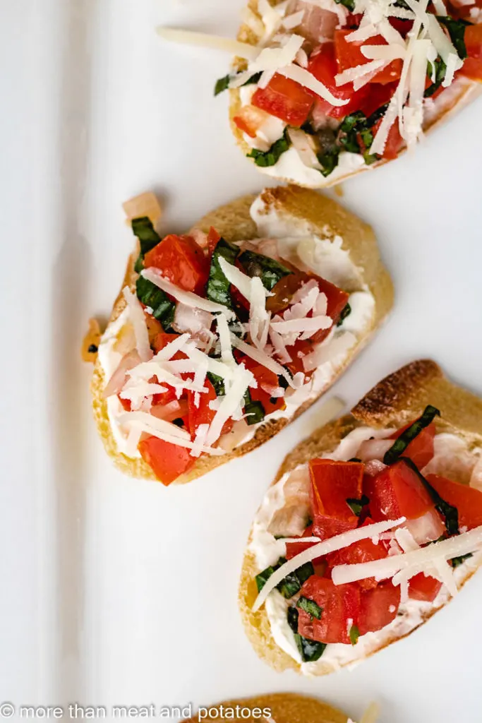 Top down view of tomato, cheese, and cream cheese on toast.