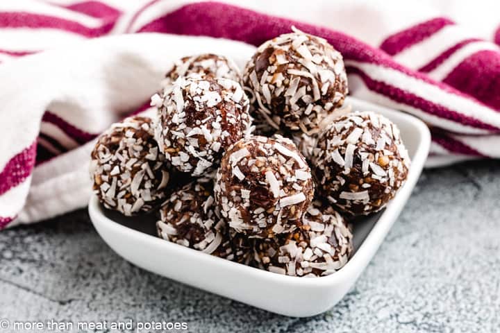 Coconut date balls in a dish.