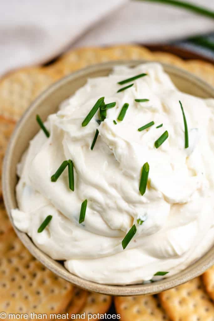 Top down view of creamy garlic dip in a bowl.