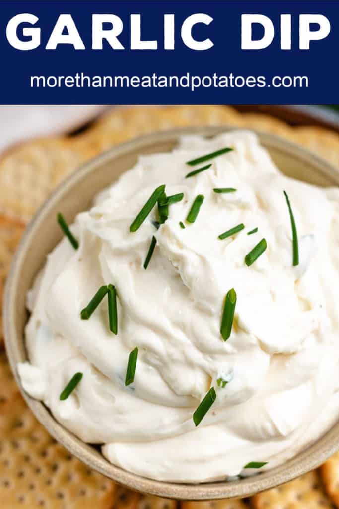 Close up of garlic flavored cream cheese dip topped with chives.