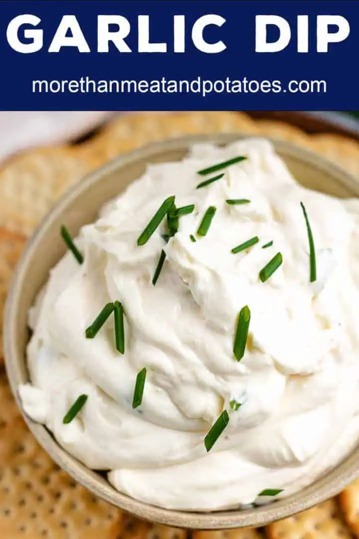 Close up of garlic flavored cream cheese dip topped with chives.