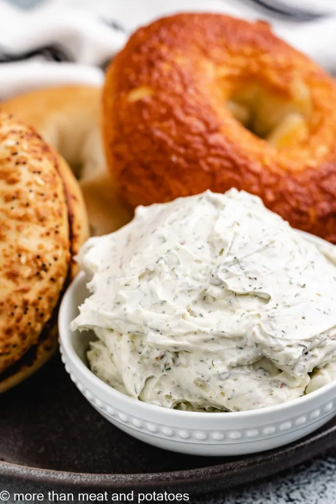 Small bowl of cream cheese with bagels.