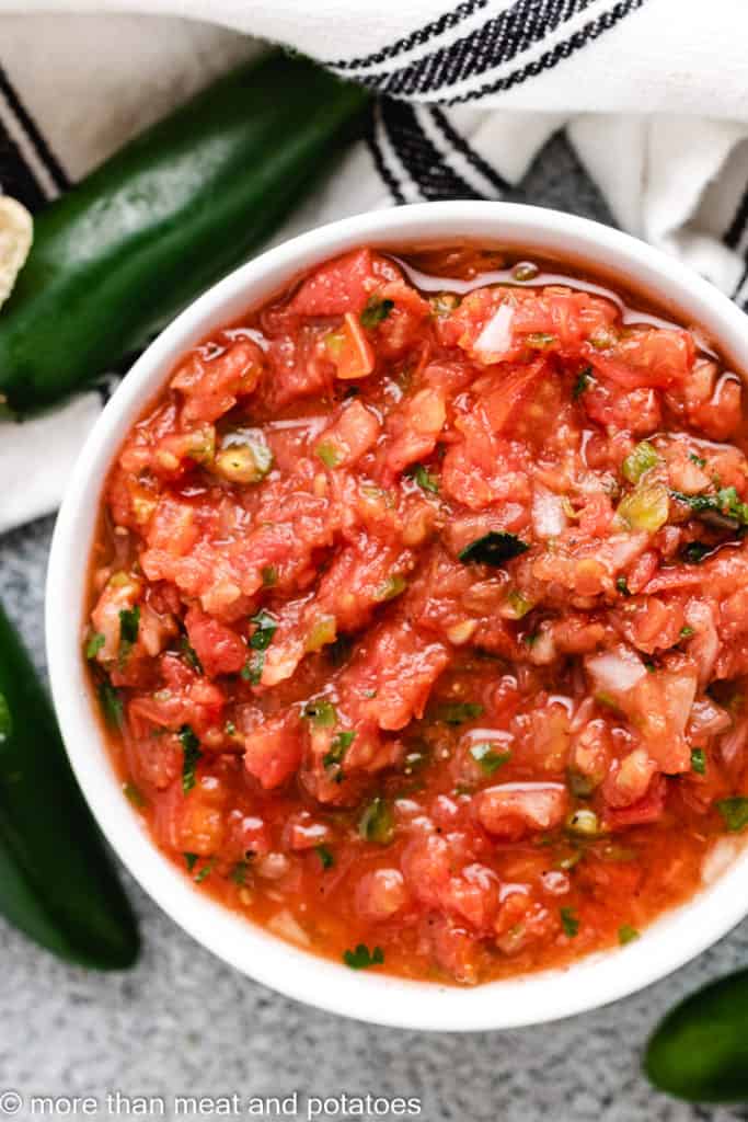 Top down view of chunky salsa in a serving bowl.