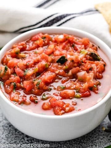Fresh tomato salsa in a white bowl.