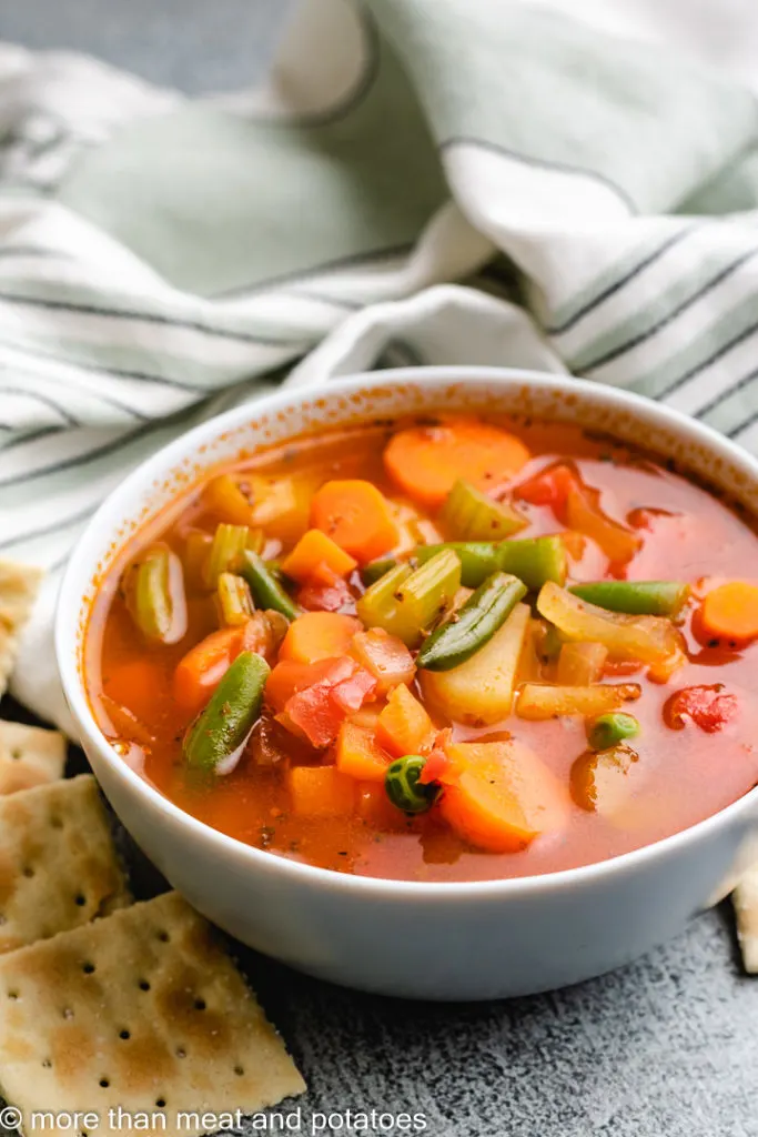 Homemade vegetable soup in a blue bowl.