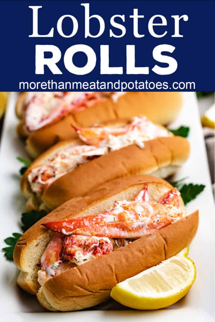 Four lobster rolls on a white plate.