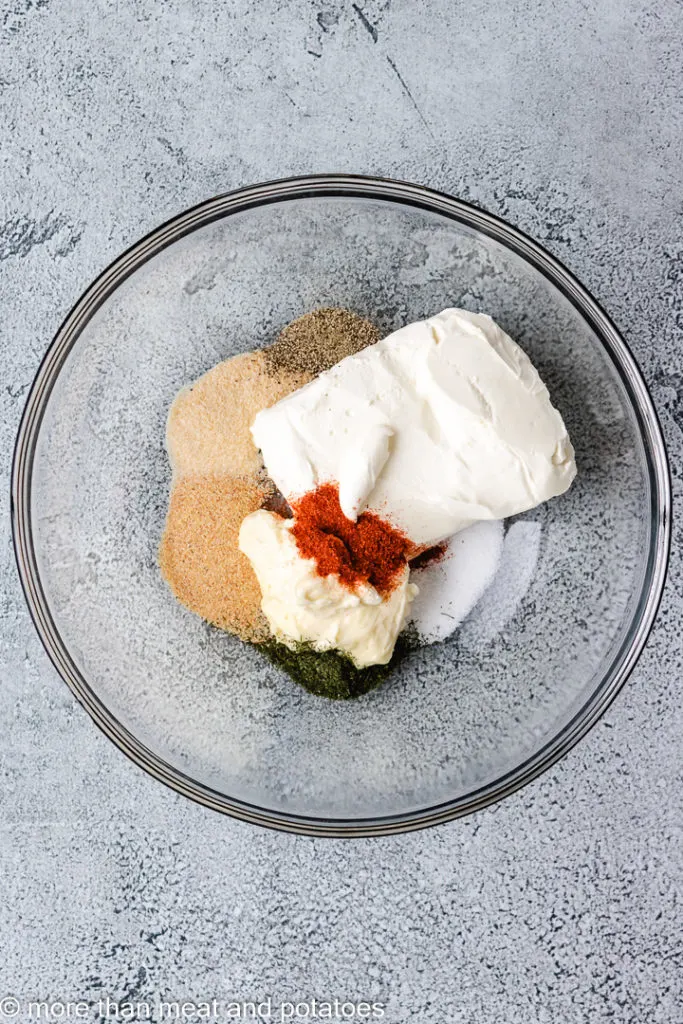 Cream cheese, mayonnaise, and spices in a bowl.