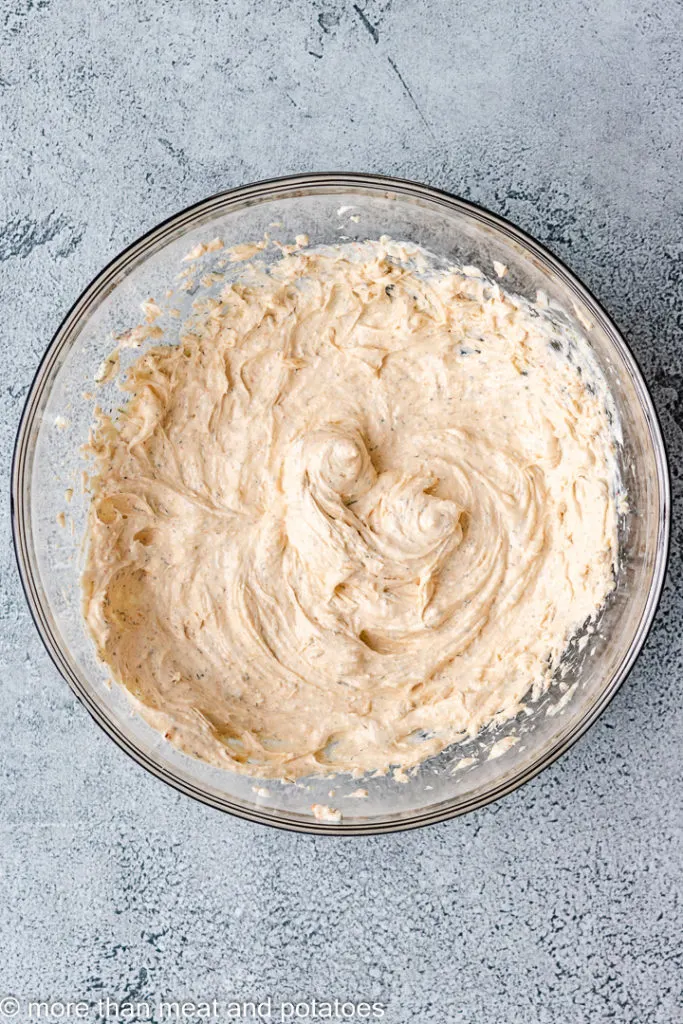 Ranch dip in a large glass bowl.