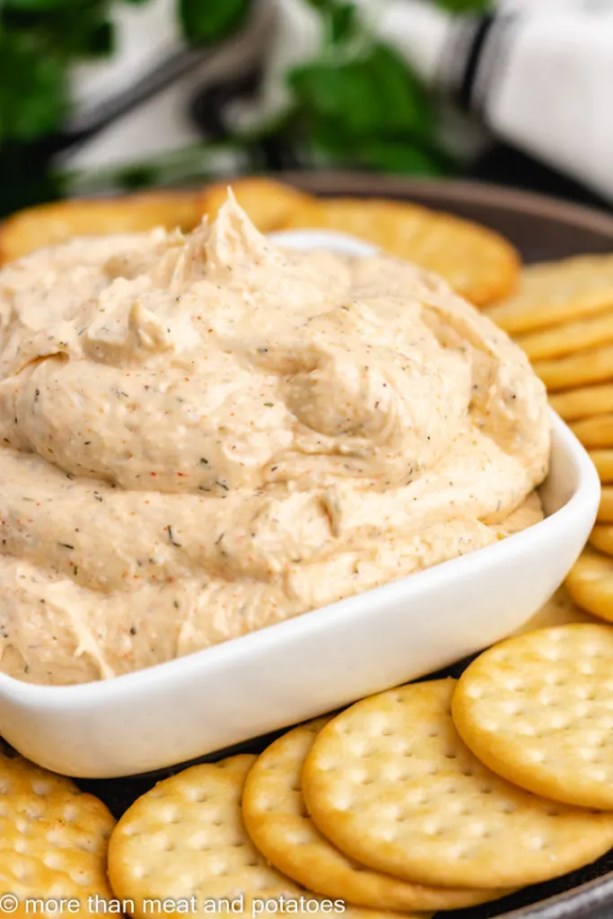 Square white bowl filled with ranch dip.