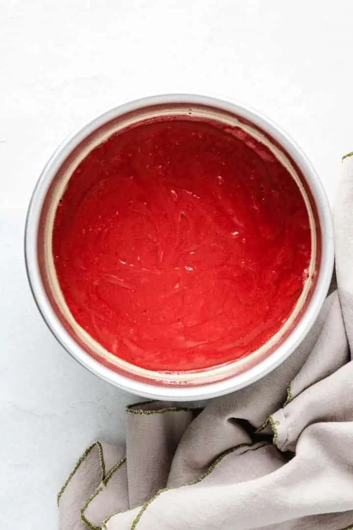 Red velvet cake batter in a pan.