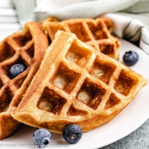Sourdough waffles with blueberries on a plate.