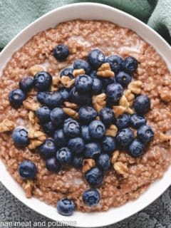Close up view of oatmeal with fruit and nuts.