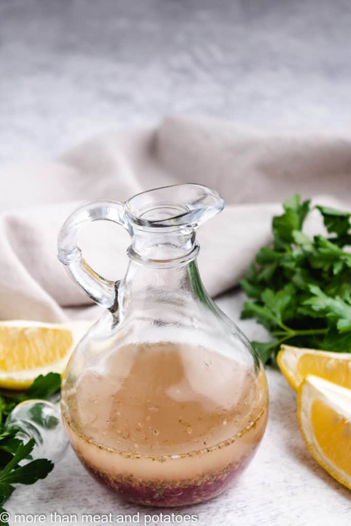 Greek dressing in a glass containter.