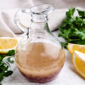 Glass jar filled with pink salad dressing.