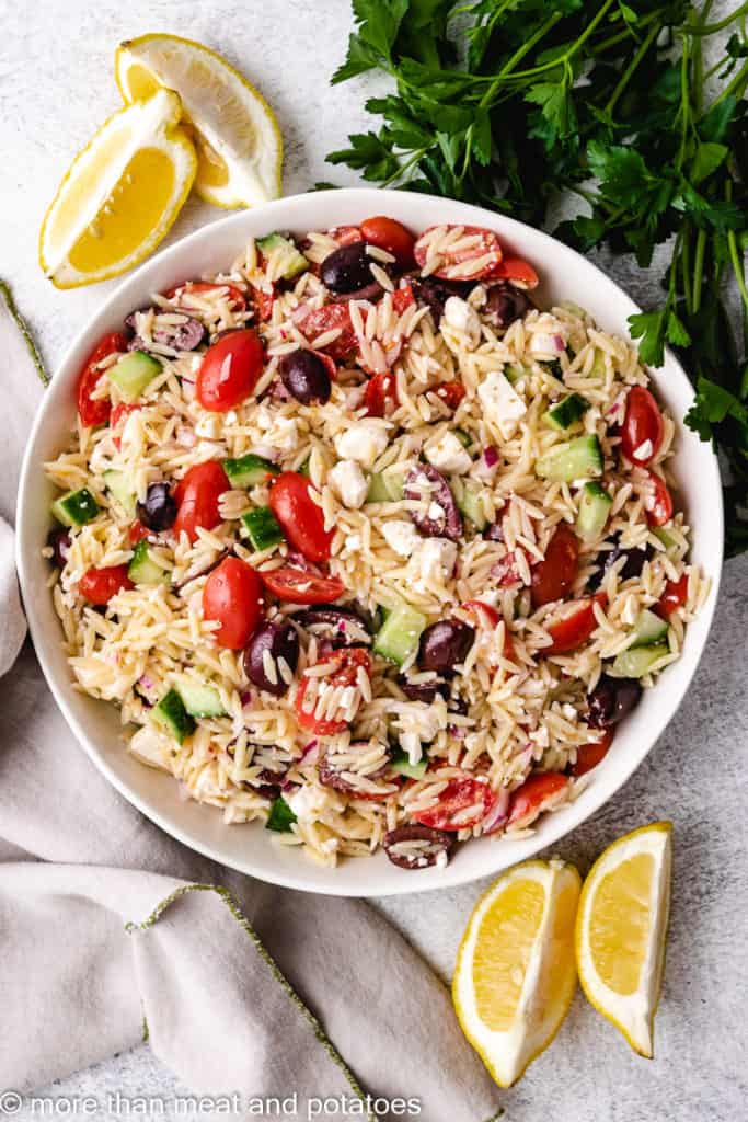Top down view of orzo salad in a dish.