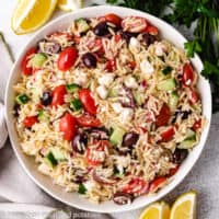 Top down view of orzo salad in a serving dish.