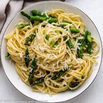 Top down view of pasta with cheese on a plate.