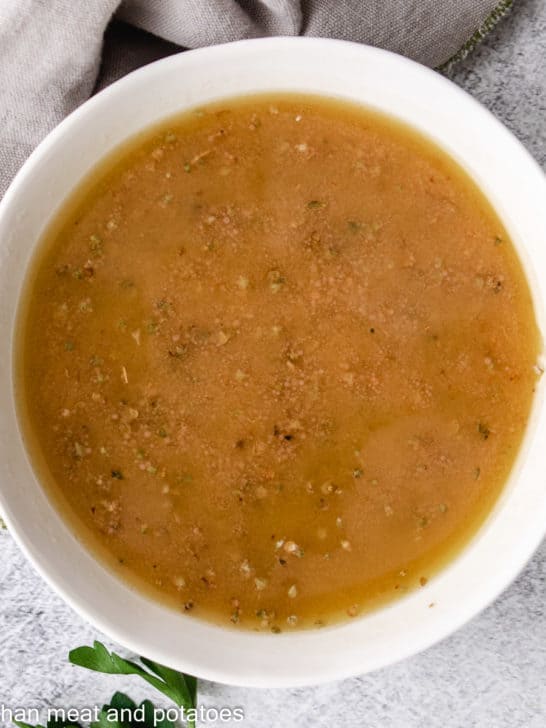 Close up of red wine vinaigrette in a small dish.