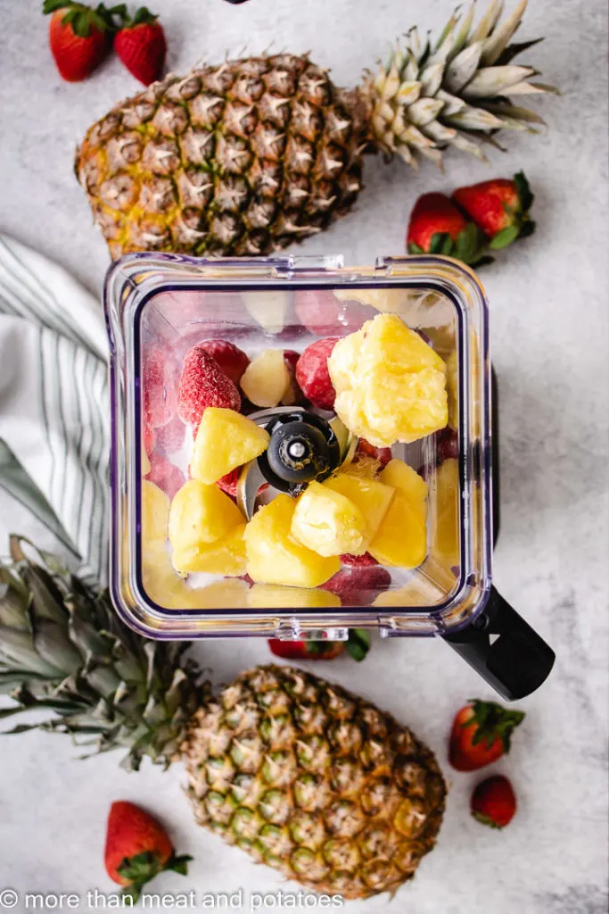 Top down view of ingredients for a smoothie in a blender.