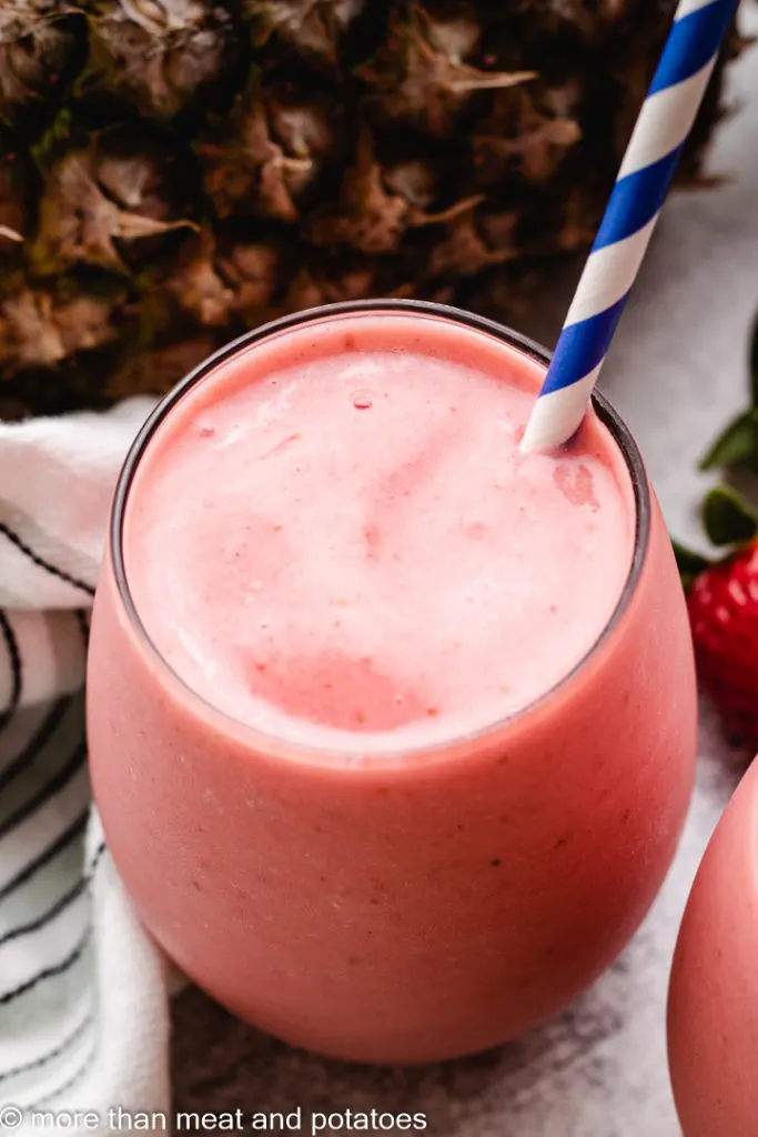 Top down view of a strawberry pineapple smoothie.