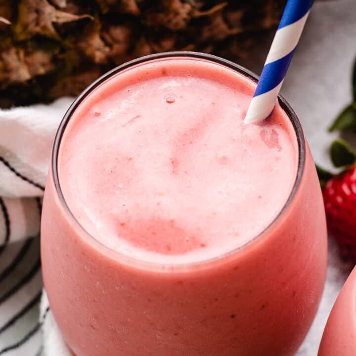 Top down view of a strawberry pineapple smoothie.