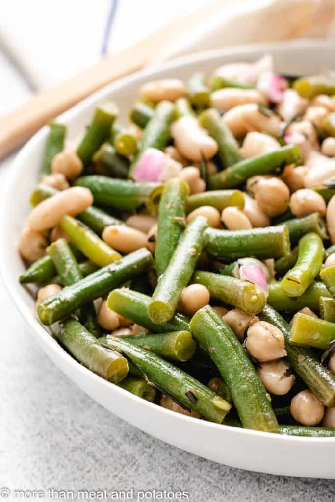 Close up view beans tossed in dressing.