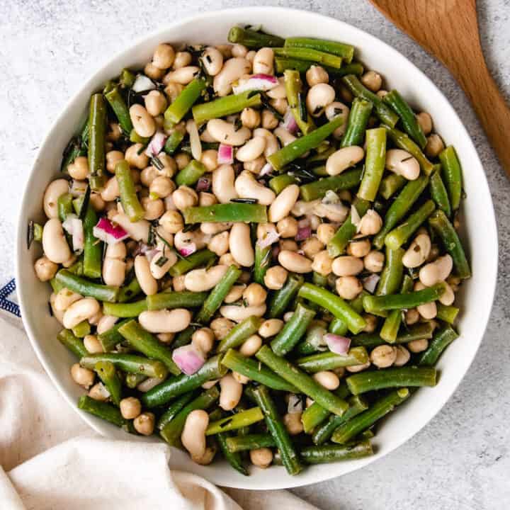 Top down view of green bean salad in a round dish.