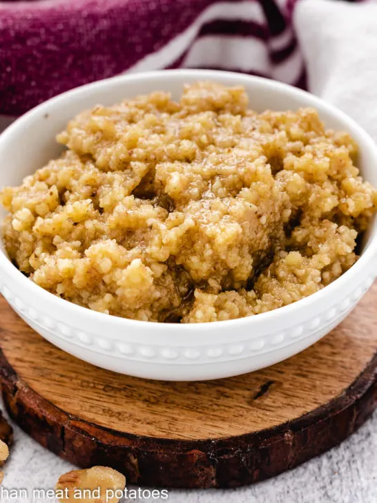 Fresh walnut pesto in a small white dish.