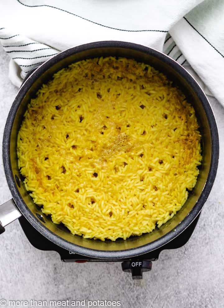 Top down view of yellow rice in pan.