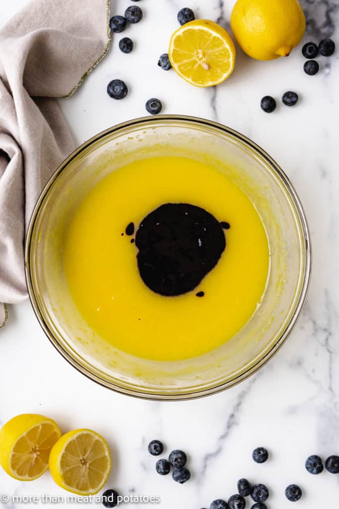 Top down view of blueberry sauce added to lemon mixture.