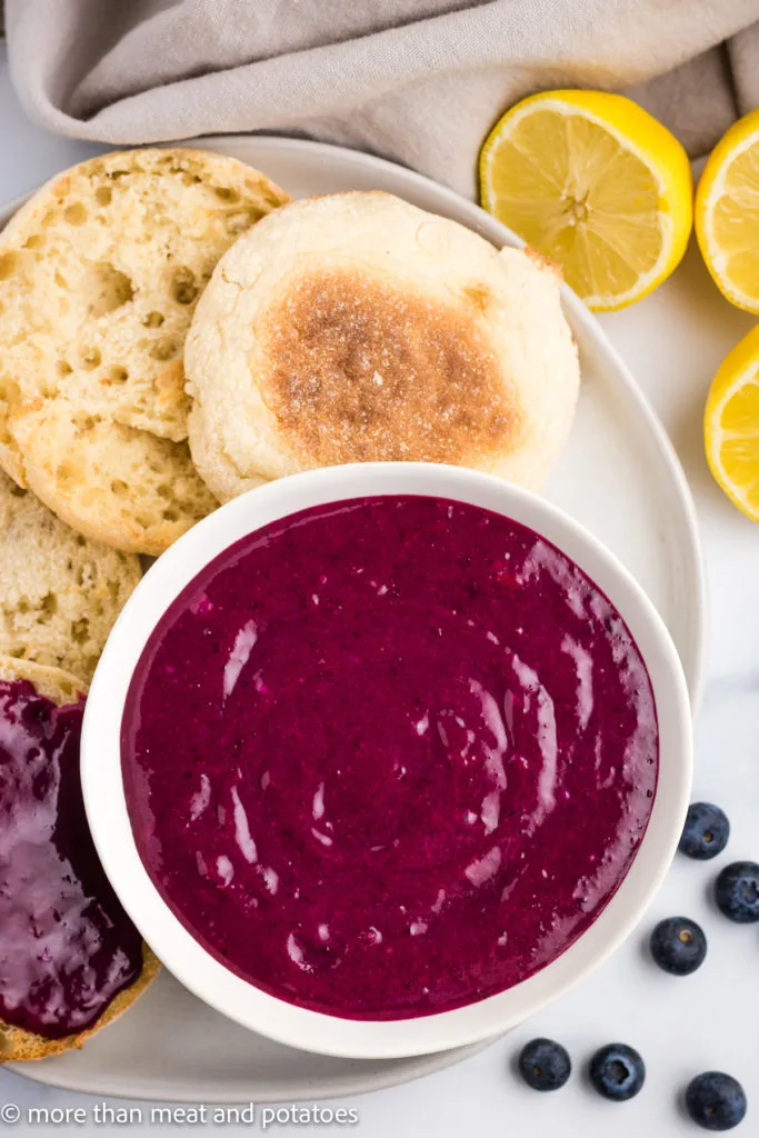 Top down view of blueberry curd with lemon slices.