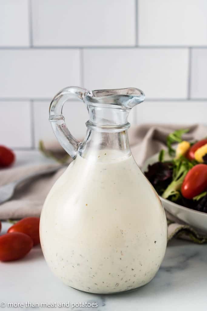 Close up of homemade ranch dressing in a glass jar.