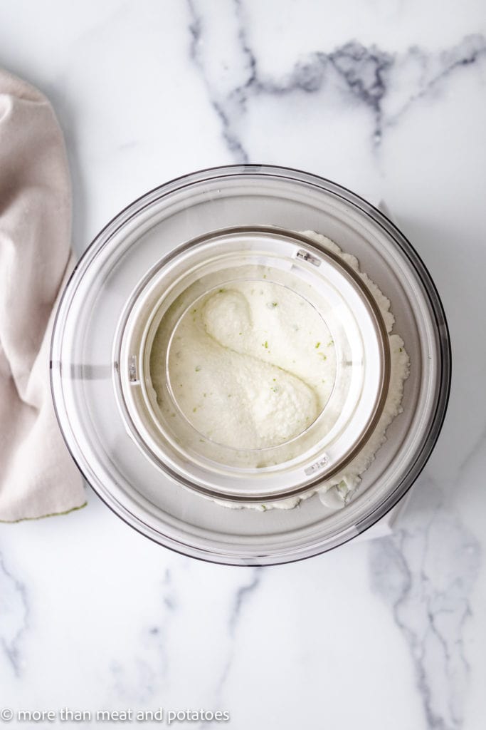 Top down view of lime sherbet in an ice cream maker.