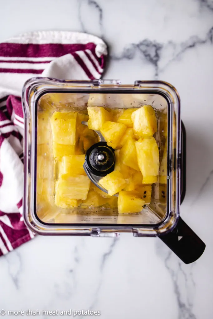 Top down view of pineapple sorbet ingredients in the blender.