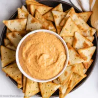 Top down view of roasted red pepper dip on a serving plate.