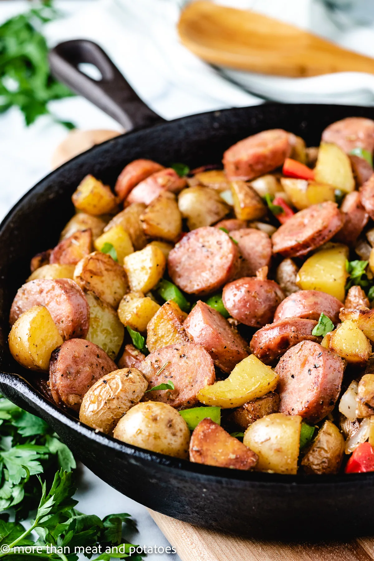 Sausage potatoes and peppers in cast iron.