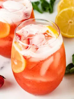 Strawberry basil lemonade in two glasses.