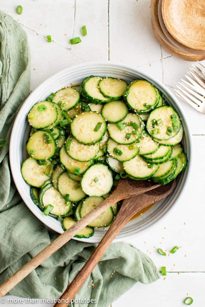 Top down view of cucumbers with dressing.