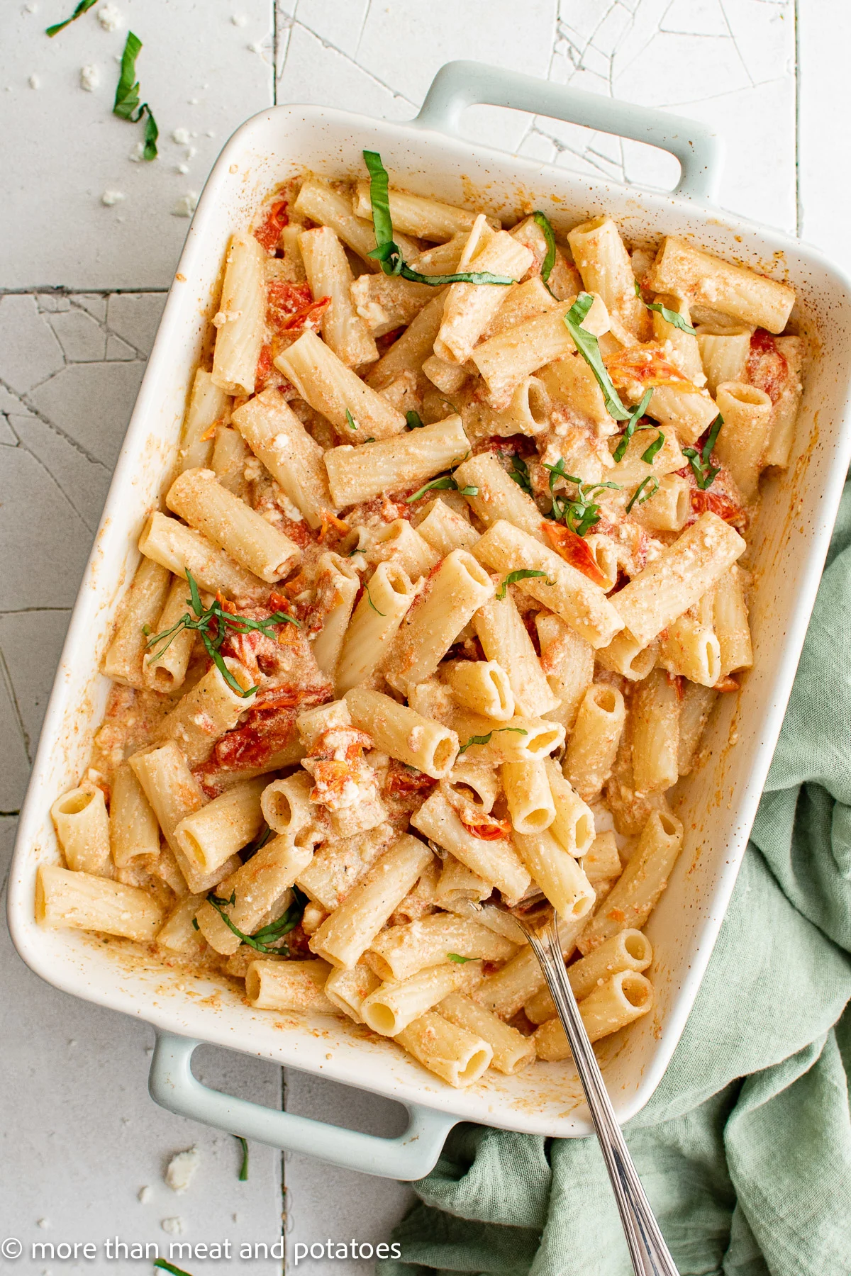 Top down view of a rectangle baking dish with feta tomato pasta.