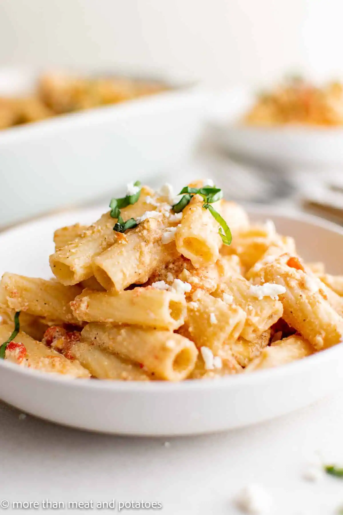 Baked pasta scooped onto a white dish.