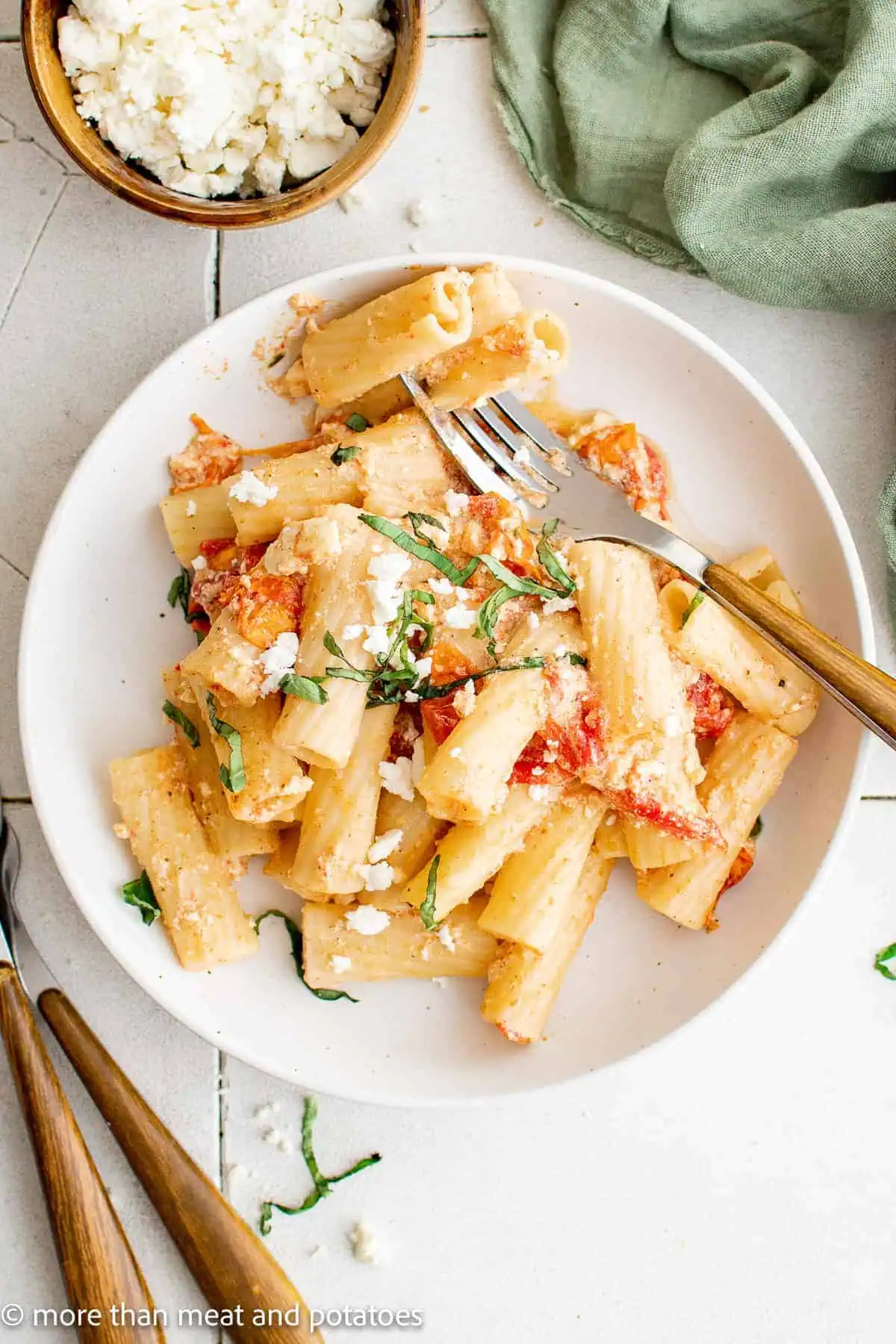 Top down view of baked feta pasta on a white dish.