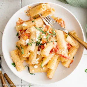 Top down view of feta pasta on a round plate.