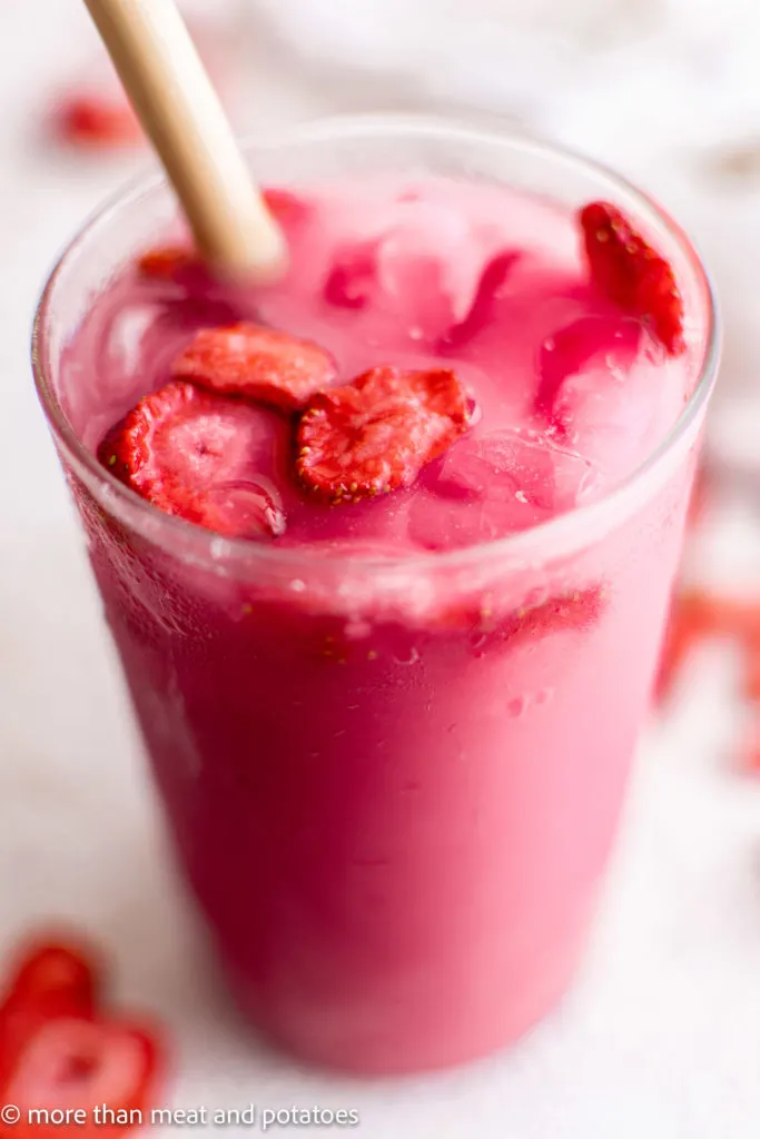 Close up of strawberries on ice in a glass.