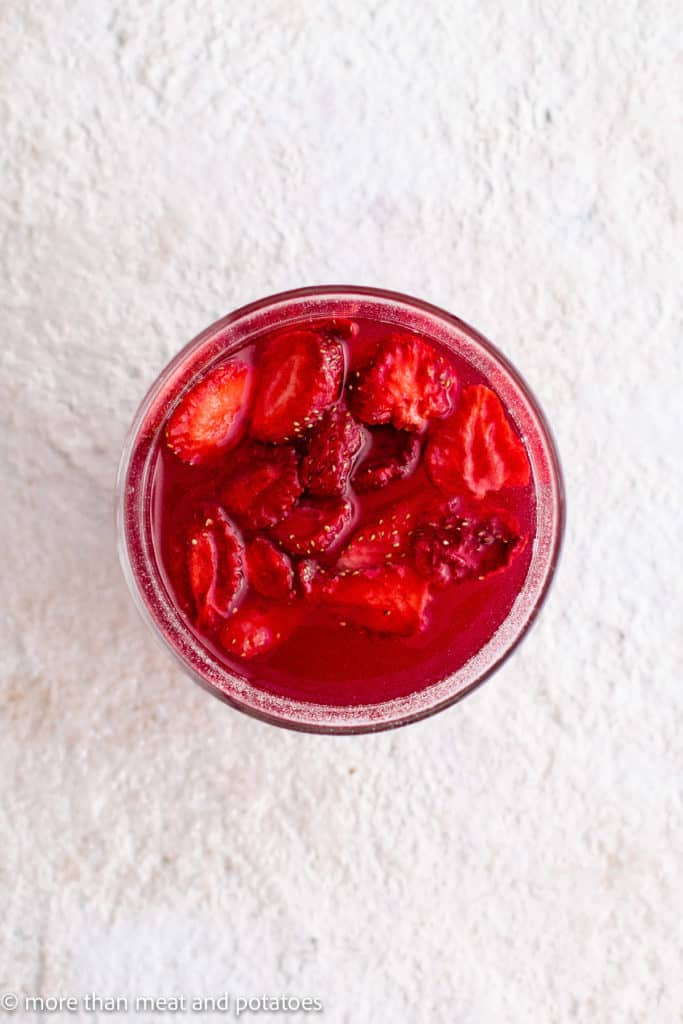 Top down view of strawberries in a glass.