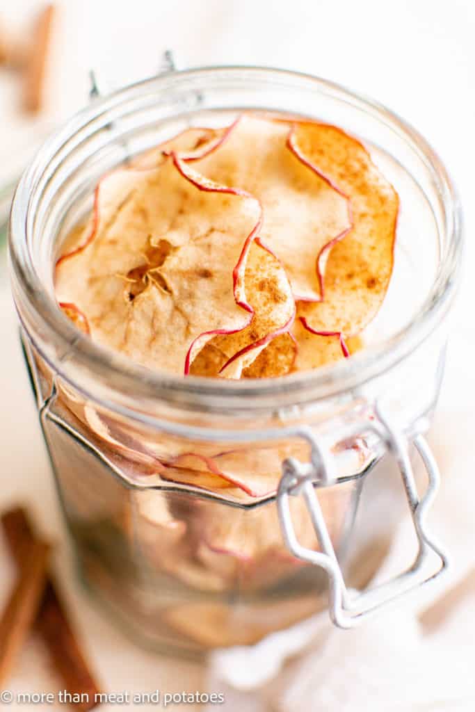 Glass filled with homemade apple slices.