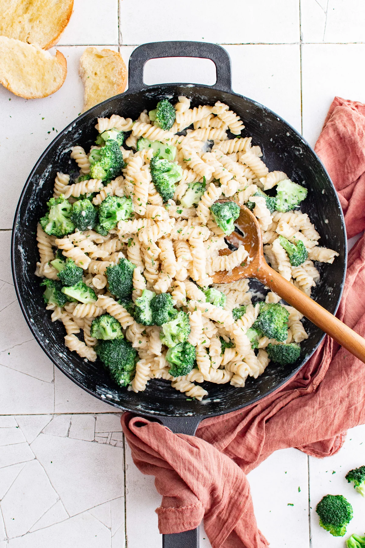 Top down view of broccoli and pasta in a pan.