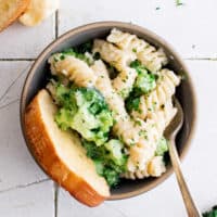 Gray bowl with pasta and broccoli.